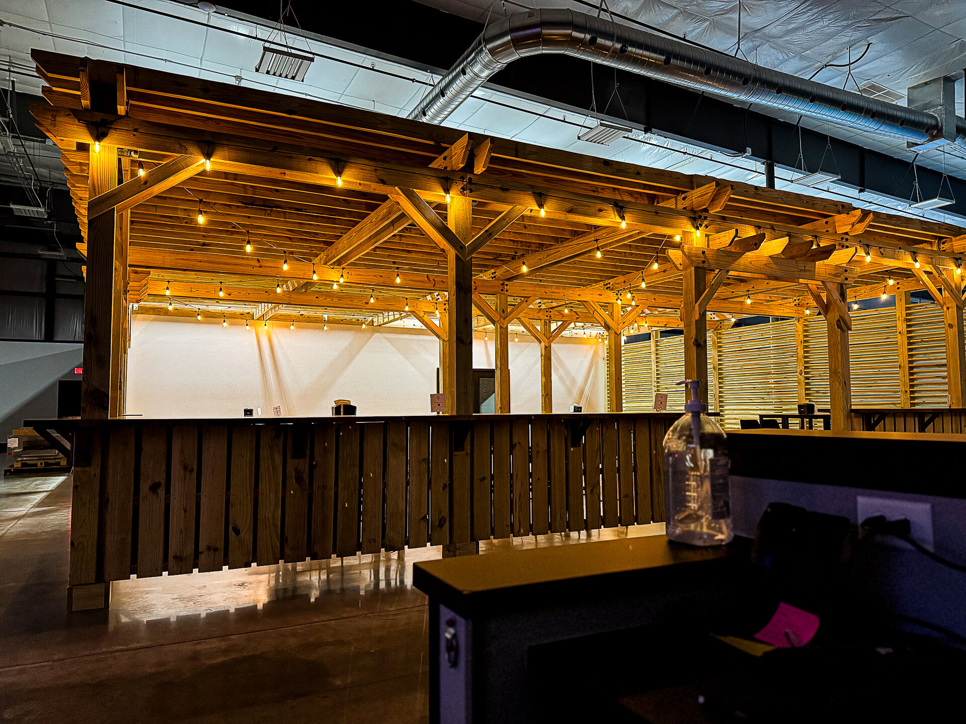 Doubles under the pergola string lights at Dual Cities NWA